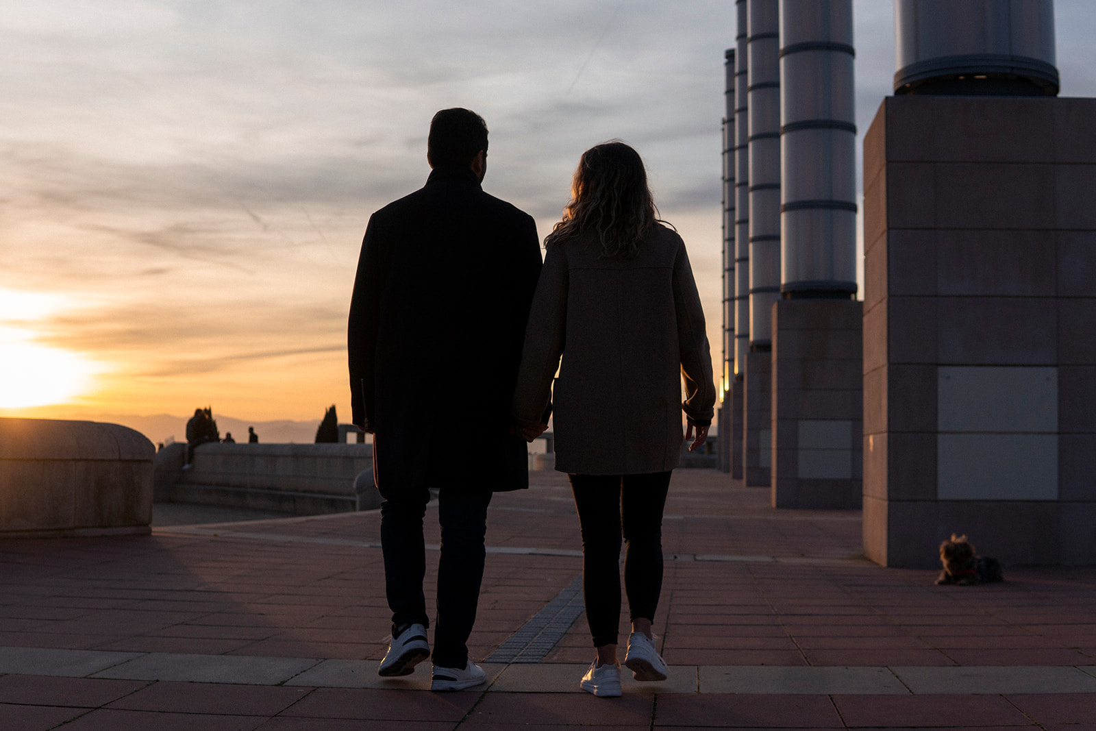 couple walking around Barcelona during sunset